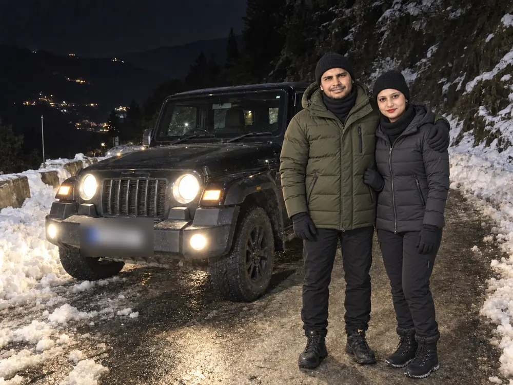 Nav and Vandana beside their Mahindra Thar on a snowy road at night
